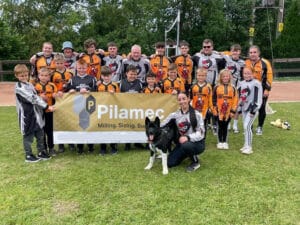 The Newport Cycle Speedway club holding a sign with the Pilamec logo on.